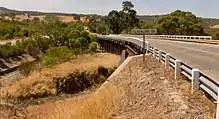 Photo of curved two-lane road bridge