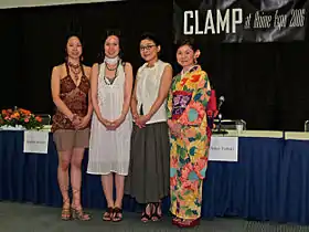 Four female manga artists standing in front of the dais at the 2006 Anime Expo