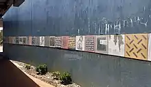 Concrete wall with artwork as described below