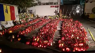 Candles and wreaths at the site of Club Colectiv