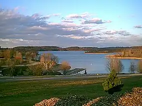 A view of the park, showing the main lake, Lake Marburg, surrounded by grass and forest.