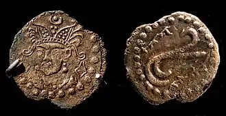 Coin in the name of Rakhanch, lord of Ushrusana. Tamgha symbol on the reverse with name of the ruler in Sogdian rγʾnč MRAY "Raxānič Afšīn". Excavated in the Palace of Kala-i Kakhkakha I, Bunjikat. 7th century CE, National Museum of Antiquities of Tajikistan (RTL 213). of Ushrusana