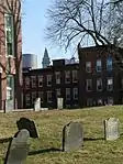 The Copp's Burying Ground in the foreground with the Custom House Tower and One International Place glimpsed in the background