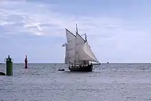 Photo shows a two-masted sailboat.