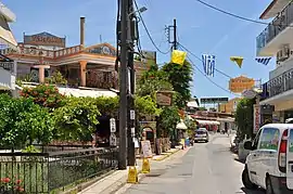 A street in Gouvia with bars and restaurants to serve the tourist market.