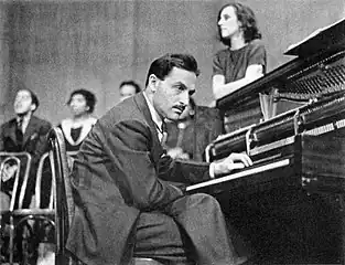 Blitzstein (with Stanton leaning on the piano, January 1938)