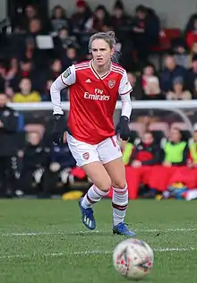 A woman in a football kit