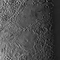 Two large cryolava lakes on Triton, seen west of Leviathan Patera. Combined, they are nearly the size of Kraken Mare on Titan. These features are unusually crater free, indicating they are young and were recently molten.