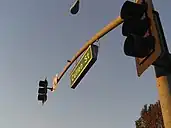 Internally illuminated mast-mounted street sign in Whittier, California