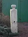 A gatepost with a Curling Stone top.