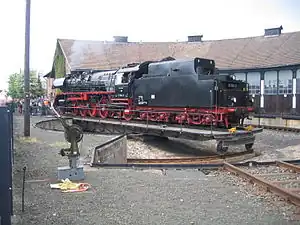 A heavy German goods locomotive on the turntable at the German Steam Locomotive Museum, Bavaria. The pivot of this turntable is off-center, which prevents the turntable from rotating a full 360 degrees.