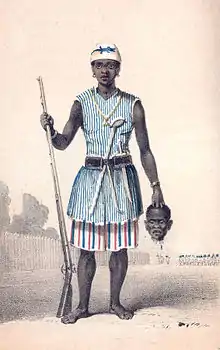 Seh-Dong-Hong-Beh, leader of the Dahomey Amazons, holding a severed head.