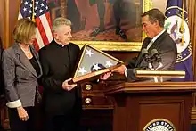 Speaker Boehner and Minority Leader Pelosi present Coughlin with a flag flown over the Capitol, 2011.