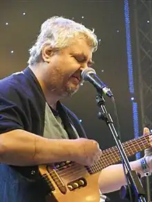 A photograph of Daniel Johnston performing