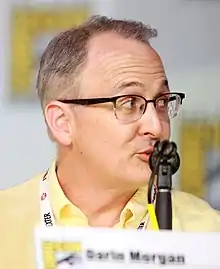 A man is speaking into a microphone.