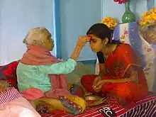 Image 7Senior offering Dashain Tika to junior (from Culture of Nepal)