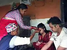 Image 1Senior offering Dashain Tika on great Nepali Hindu festival at a traditional home. (from Culture of Nepal)