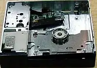 Dataplay optical drive engine internals viewed from above a unit produced without any top cover; above the circular piece is the laser pickup. The laser pickup is built on a piece of silicon.