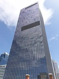 Looking up at the glass facade of the building