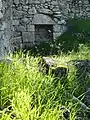 What remains of the inside wall of a house, with niche in wall