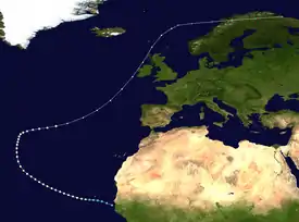 Path of a hurricane, with colored dots representing the storm's intensity at different positions in six-hour intervals. The storm begins in the lower-centre of truck the upper-right corner of the image. The colored dots reflect a gradual increase and then decrease in intensity.