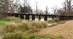 Bridge of abandoned Illinois Central Railroad line across Deer Creek in Scott