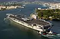 Ronald Reagan is aided by harbor tugs as she enters Pearl Harbor, Hawaii, for a port visit on 28 June 2006.