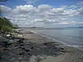 The public southern sandy beach with a view to the seabath structure.