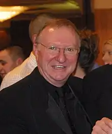 Dennis Taylor wearing a dark suit