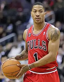 Derrick Rose holds a basketball