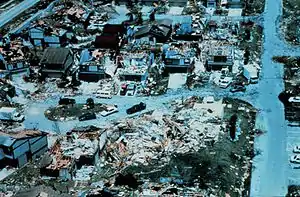 A close-up view of houses with evident wind damage