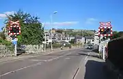 An open level crossing with warning lights and signs known as an AOCL in Dingwall, Highland