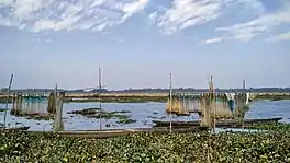 Fishing nets and boats on the Dora Beel in Kamrup district