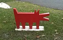 A simple statue of a red dog