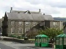 small two-storey building of flint and sandstone