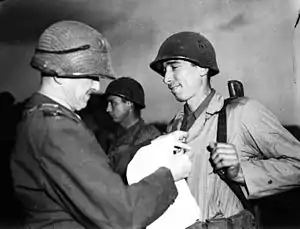 Sgt. Alexander A. Drabik receiving a Distinguished Service Cross for his actions during the Battle of Remagen from the MG John W. Leonard, Commanding officer of the 9th Armored Division.