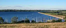 A lake with pleasure craft docked in the foreground