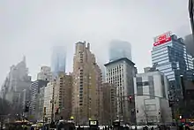 View of 240 Central Park South from across Columbus Circle on a foggy day