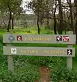 Old CALM sign with various labels, marsh area of south west corner in background