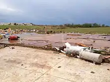 EF5 damage example--These tornadoes cause complete destruction, obliterating and sweeping away almost anything in their paths, including those sheltering in open basements, sending any vehicles or trains flying through the air, and causing tall buildings to collapse or to have severe structural deformations. Brick, cinderblock, and concrete not immune to becoming projectiles.