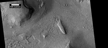 Layered features and brain terrain, as seen by HiRISE under HiWish program  The upper plains unit often changes into brain terrain.