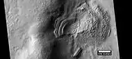 Layered feature that is probably the remains of a once widespread unit that fell from the sky, as seen by HiRISE under the HiWish program