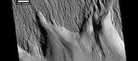 Surface features along a scarp in Medusae Fossae formation, as seen by HiRISE under HiWish program Location is Memnonia quadrangle.