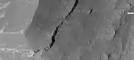 Edge of mesa on floor of Noctis Labyrinthus showing layers; enlargement from the same image as previous.