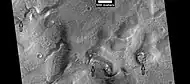 Layered features in channels and depressions, as seen by HiRISE under HiWish program Arrows point to some of the layered features.