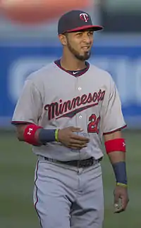 A man wearing a gray baseball uniform with "Minnesota" on the chest