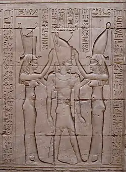 Pharaoh Ptolemy VIII between the goddesses Wadjet (symbolizing  lower Egypt) and Nekhbet (symbolizing upper Egypt). Bas-relief on wall of Temple of Edfu, Egypt