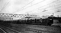 View of Eight Coach Electric Train approaching Kurla, Mumbai, Maharashtra, India.