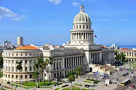 El Capitolio, seen from a rooftop to its southeast. The building and its dome make up the entirety of the center of the image, running from the foreground in the lower left to the background in the middle-right.