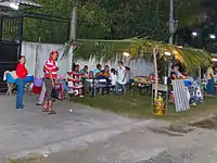 An outdoor pupusería in El Salvador at night